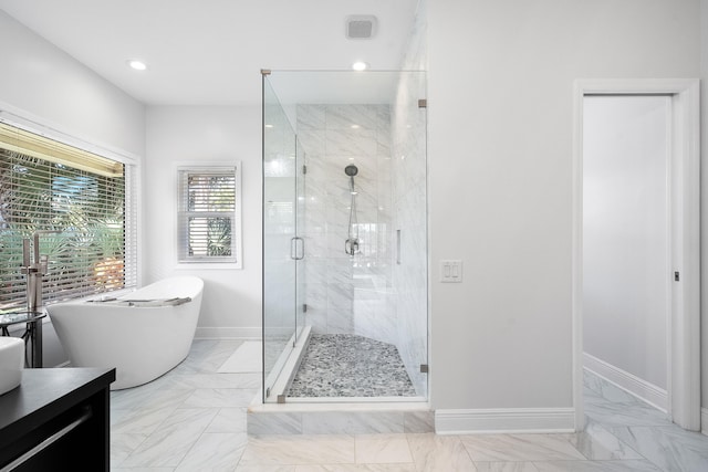 bathroom with vanity and independent shower and bath