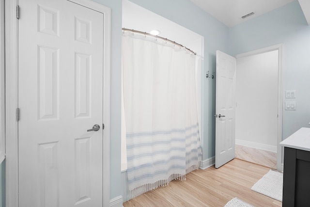 bathroom featuring a shower with curtain, vanity, and hardwood / wood-style floors