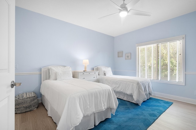 bedroom with ceiling fan and light wood-type flooring