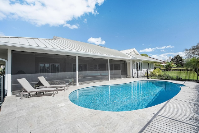 view of pool featuring a sunroom and a patio area