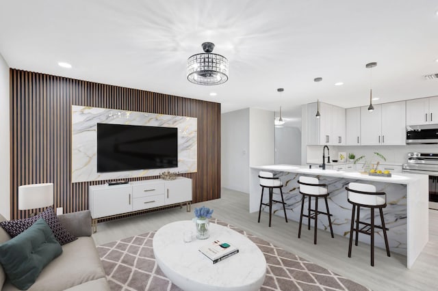 living room with sink and light hardwood / wood-style floors