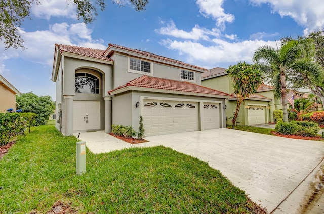 mediterranean / spanish-style home with a garage and a front yard