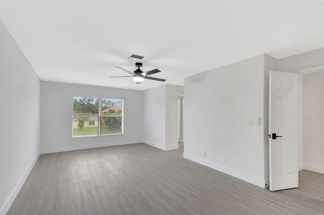 empty room featuring ceiling fan and light hardwood / wood-style floors