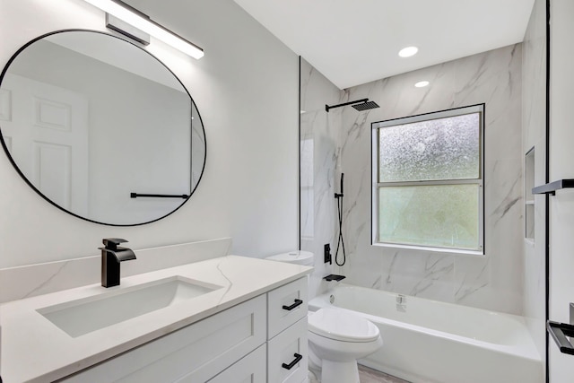 full bathroom with vanity, tiled shower / bath combo, and toilet