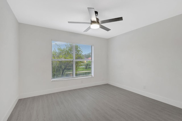 unfurnished room with hardwood / wood-style flooring and ceiling fan