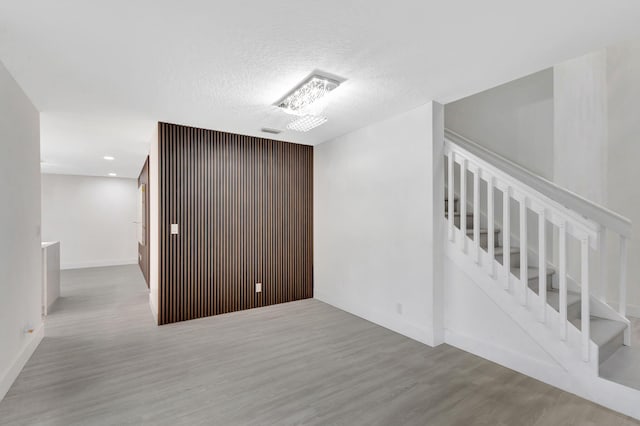 empty room featuring a textured ceiling and light wood-type flooring