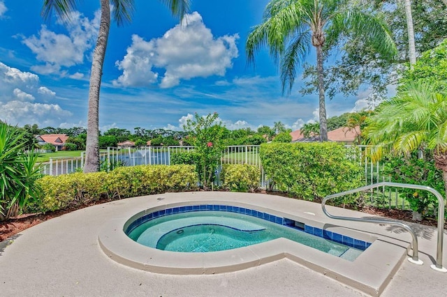 view of pool featuring a water view and an in ground hot tub