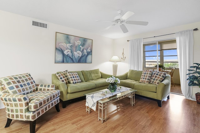 living room with hardwood / wood-style floors and ceiling fan