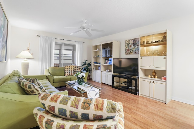 living room featuring light hardwood / wood-style flooring and ceiling fan