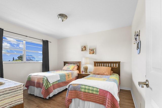 bedroom with dark hardwood / wood-style flooring