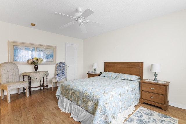 bedroom featuring a closet, ceiling fan, and light wood-type flooring