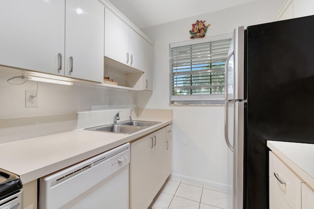 kitchen with sink, white cabinetry, light tile patterned floors, stainless steel refrigerator, and white dishwasher