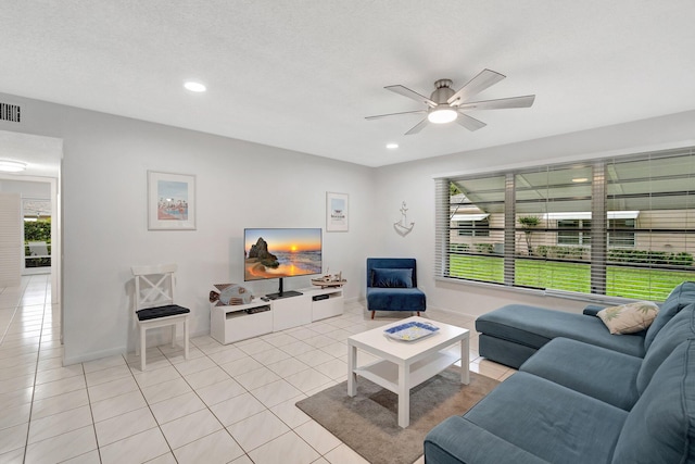 tiled living room featuring a textured ceiling and ceiling fan