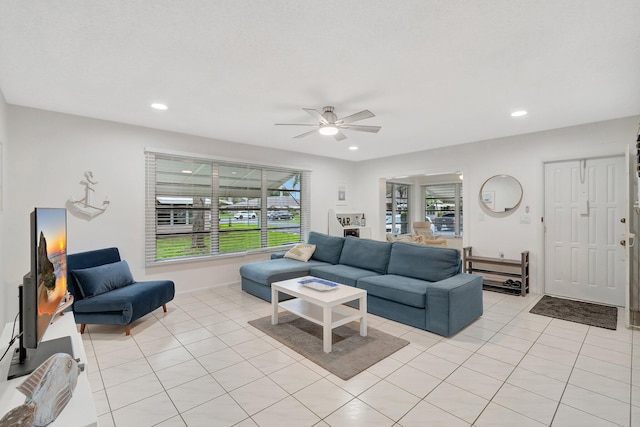 tiled living room featuring a healthy amount of sunlight and ceiling fan