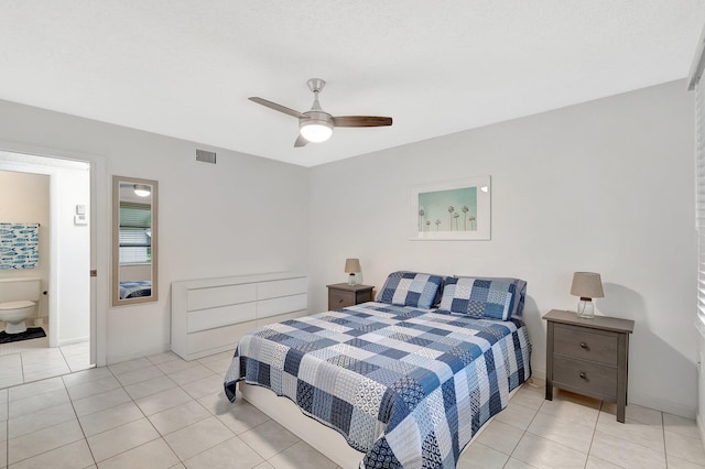 tiled bedroom with ceiling fan and ensuite bath