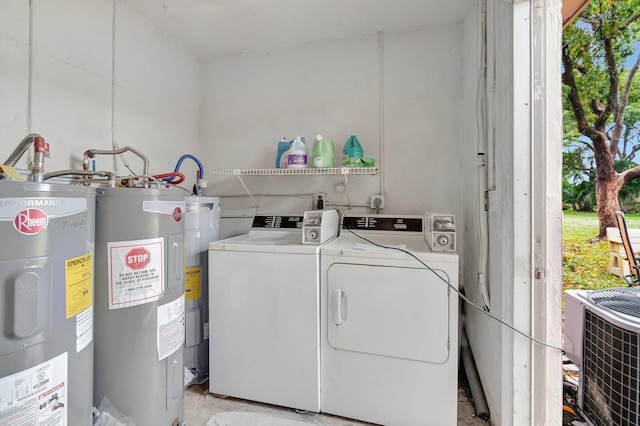 washroom with electric water heater and washer and clothes dryer