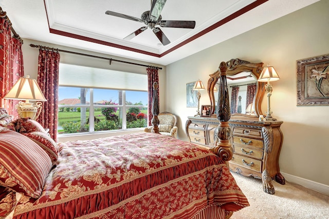 bedroom featuring ornamental molding, a raised ceiling, ceiling fan, and carpet flooring