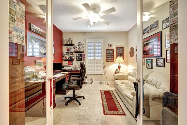 office featuring light tile patterned floors, a textured ceiling, and ceiling fan