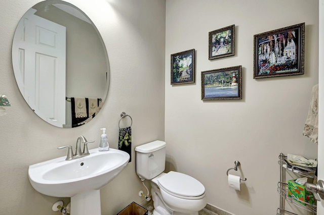 bathroom featuring sink and toilet