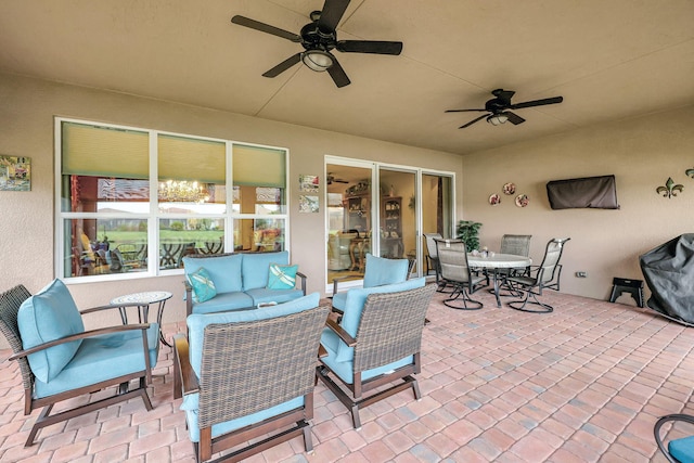 view of patio with an outdoor living space and ceiling fan