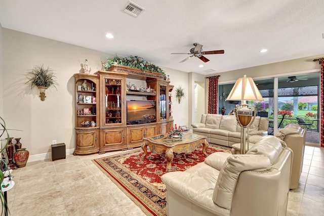 living room with light tile patterned floors and ceiling fan