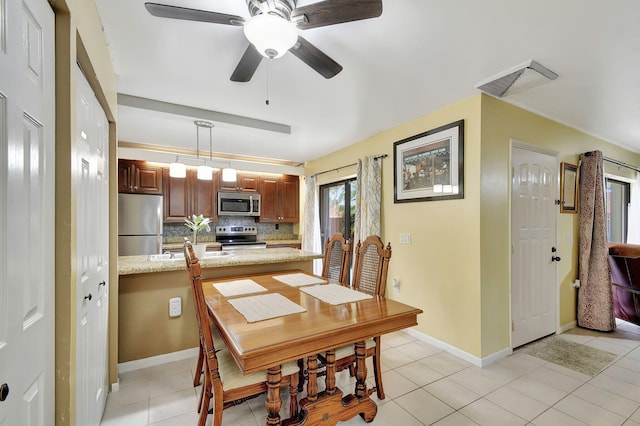 tiled dining room featuring ceiling fan