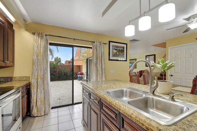 kitchen with range with electric cooktop, pendant lighting, sink, light tile patterned floors, and ceiling fan