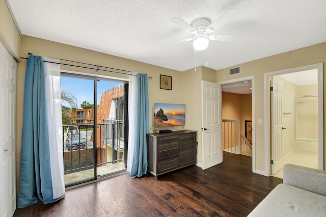 interior space featuring ceiling fan, dark hardwood / wood-style floors, and a textured ceiling