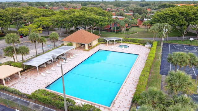 view of swimming pool featuring a gazebo, a community hot tub, and a patio area