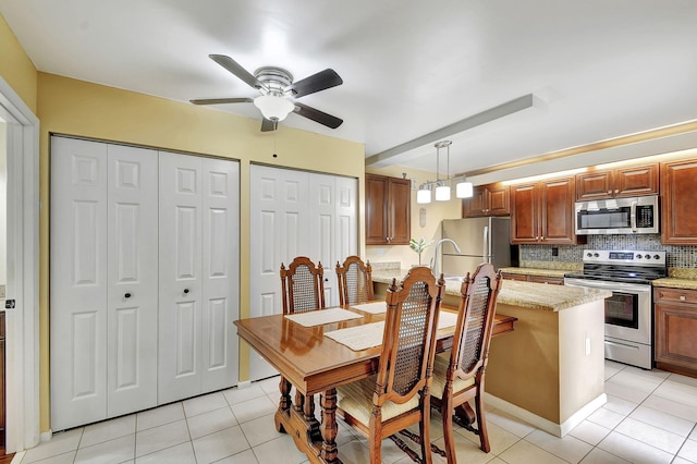 tiled dining space featuring ceiling fan