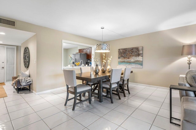 dining space featuring light tile patterned floors