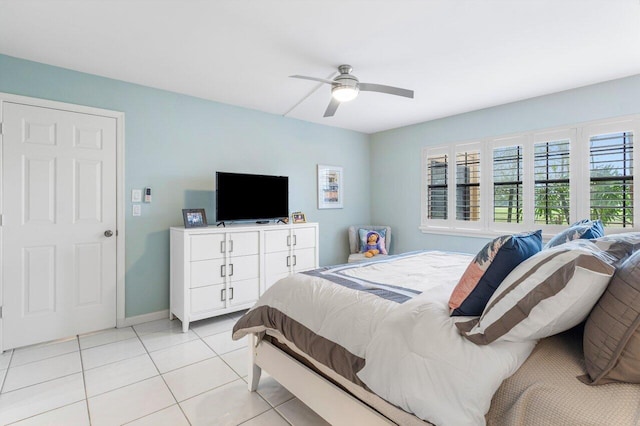 tiled bedroom featuring ceiling fan