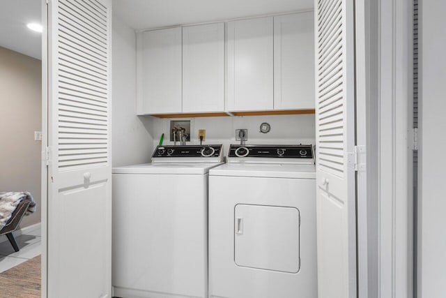 laundry room with cabinets and washer and clothes dryer