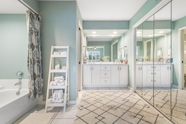 bathroom featuring vanity, a tub to relax in, and tile patterned flooring