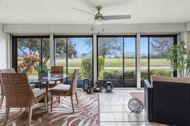 sunroom featuring ceiling fan