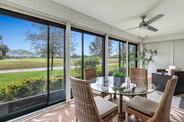 sunroom / solarium featuring ceiling fan