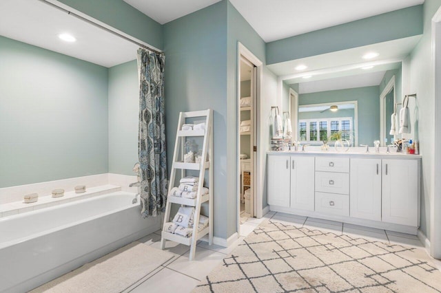 bathroom with vanity, a bath, and tile patterned floors