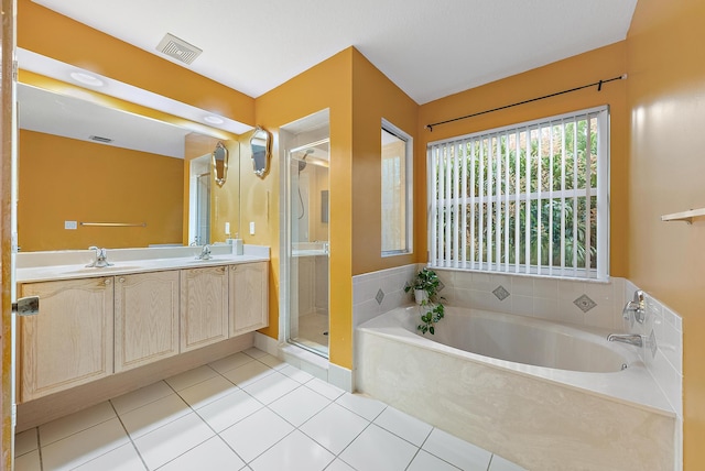 bathroom with tile patterned flooring, vanity, and separate shower and tub