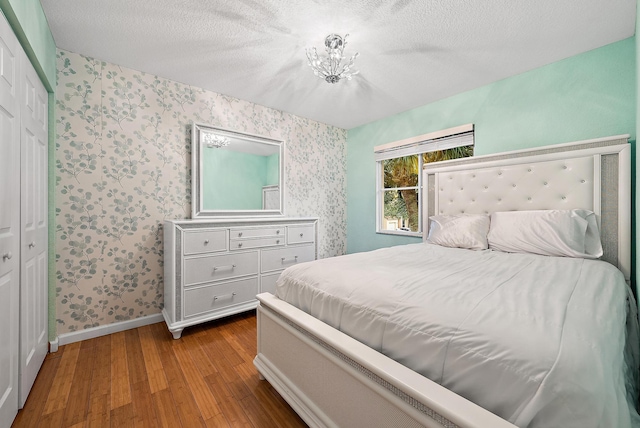 bedroom with hardwood / wood-style flooring and a textured ceiling