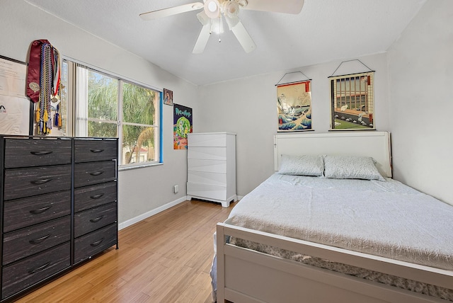 bedroom with ceiling fan and light hardwood / wood-style floors