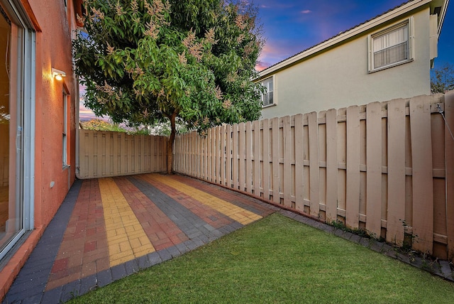 yard at dusk with a patio area