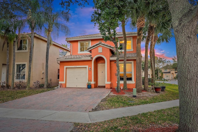 mediterranean / spanish-style house with a garage