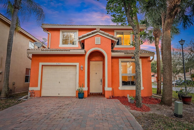 mediterranean / spanish-style home with a garage