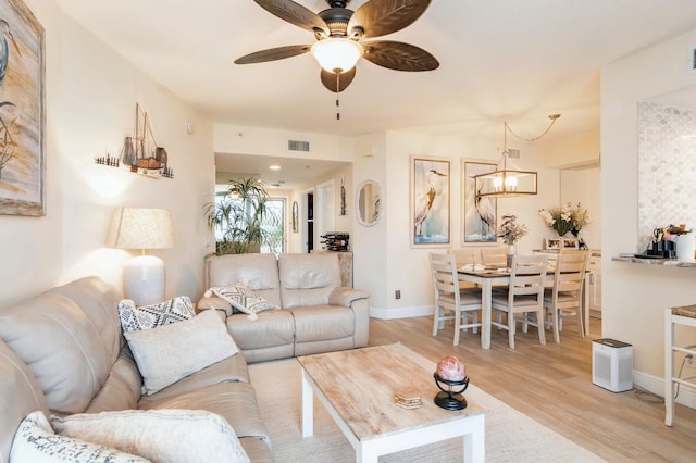 living room with ceiling fan and light wood-type flooring