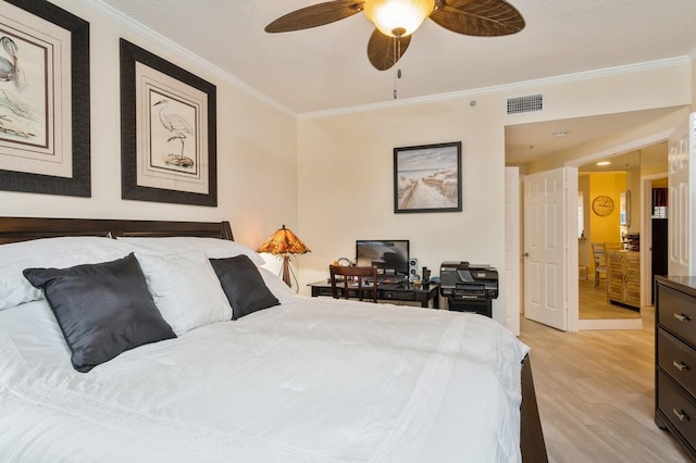 bedroom with crown molding, ceiling fan, and light hardwood / wood-style floors