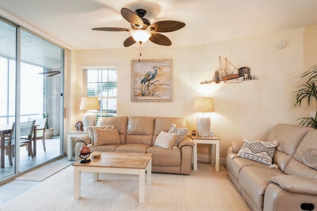 living room featuring ceiling fan and light wood-type flooring