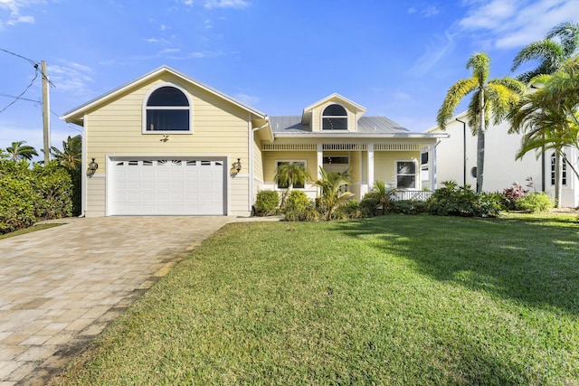 view of front of home featuring a garage, covered porch, and a front lawn