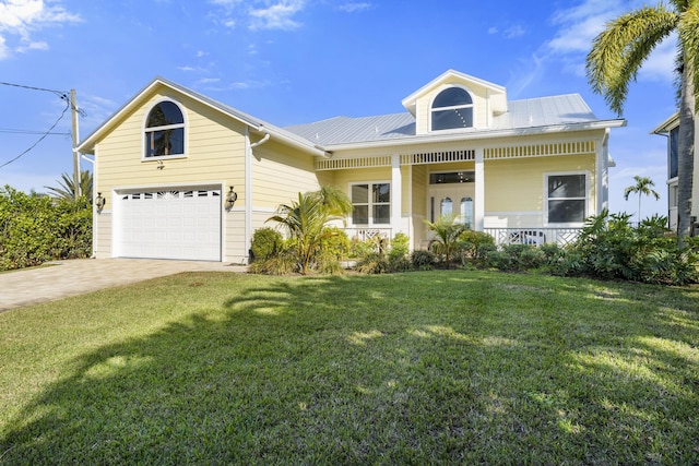 view of front of house with a garage, covered porch, and a front lawn