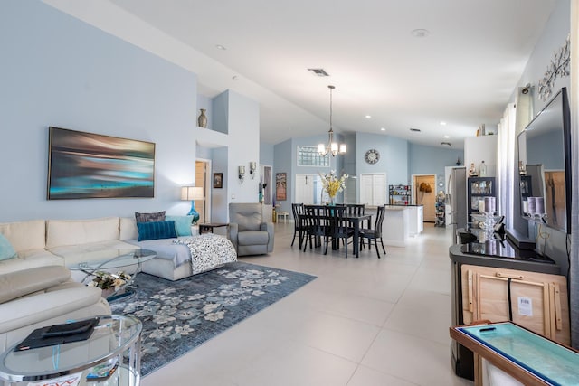 tiled living room featuring a chandelier and high vaulted ceiling