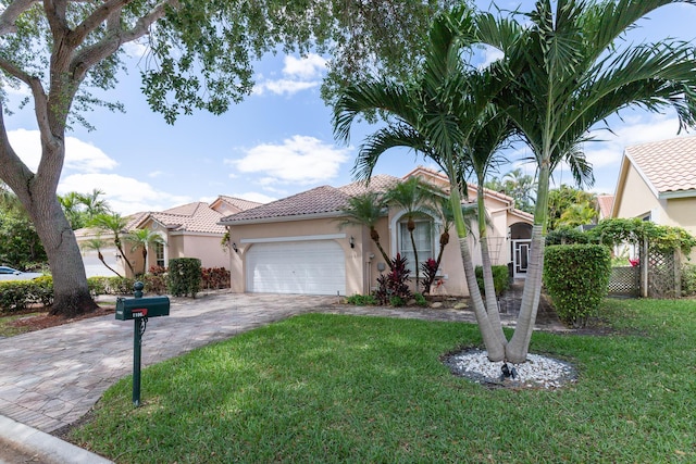 mediterranean / spanish-style house with a garage and a front yard